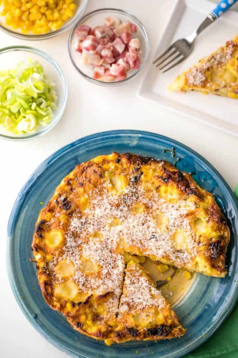 pancetta, corn, and leek frittata with small bowls of ingredients