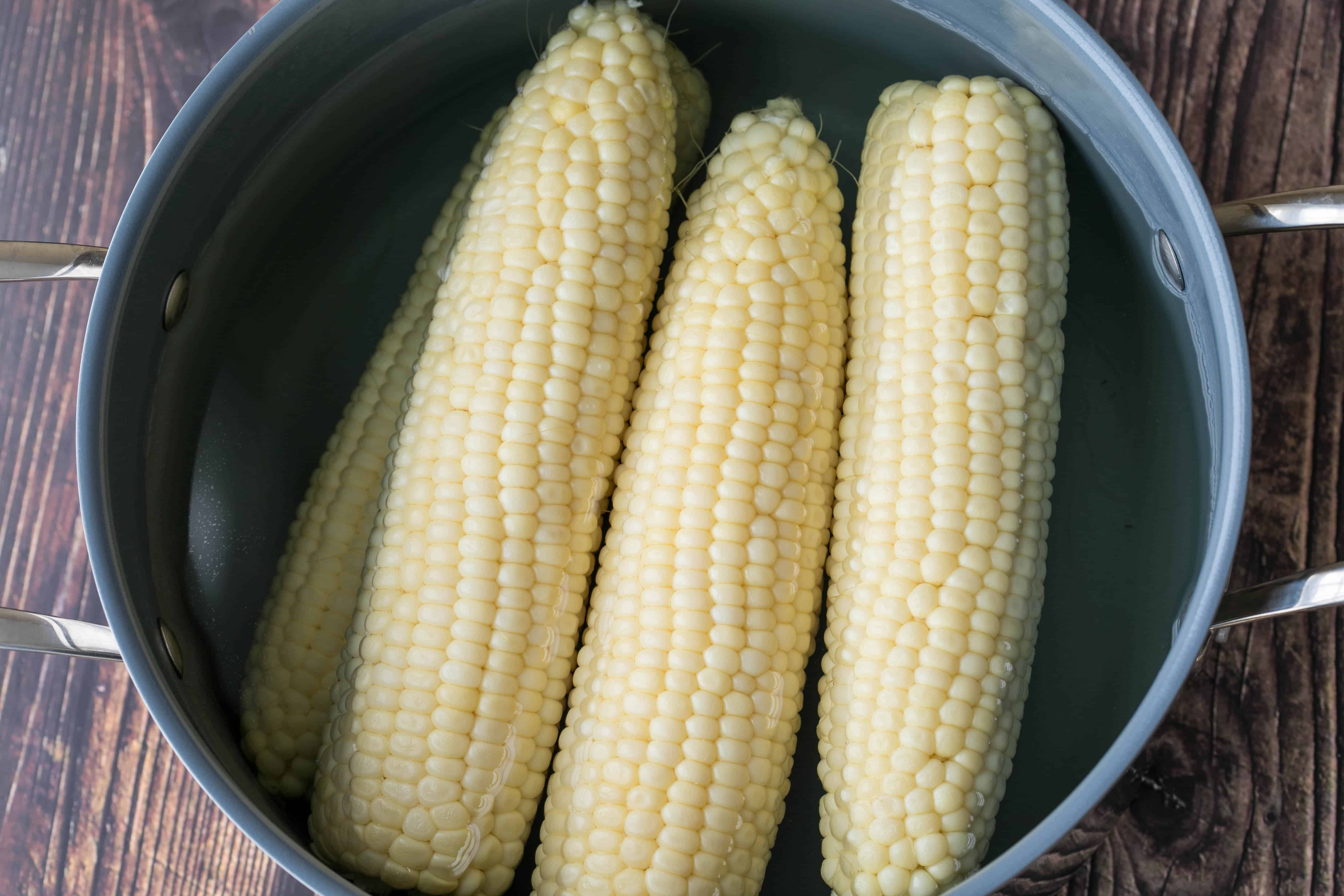 large pot of boiled corn on the cob