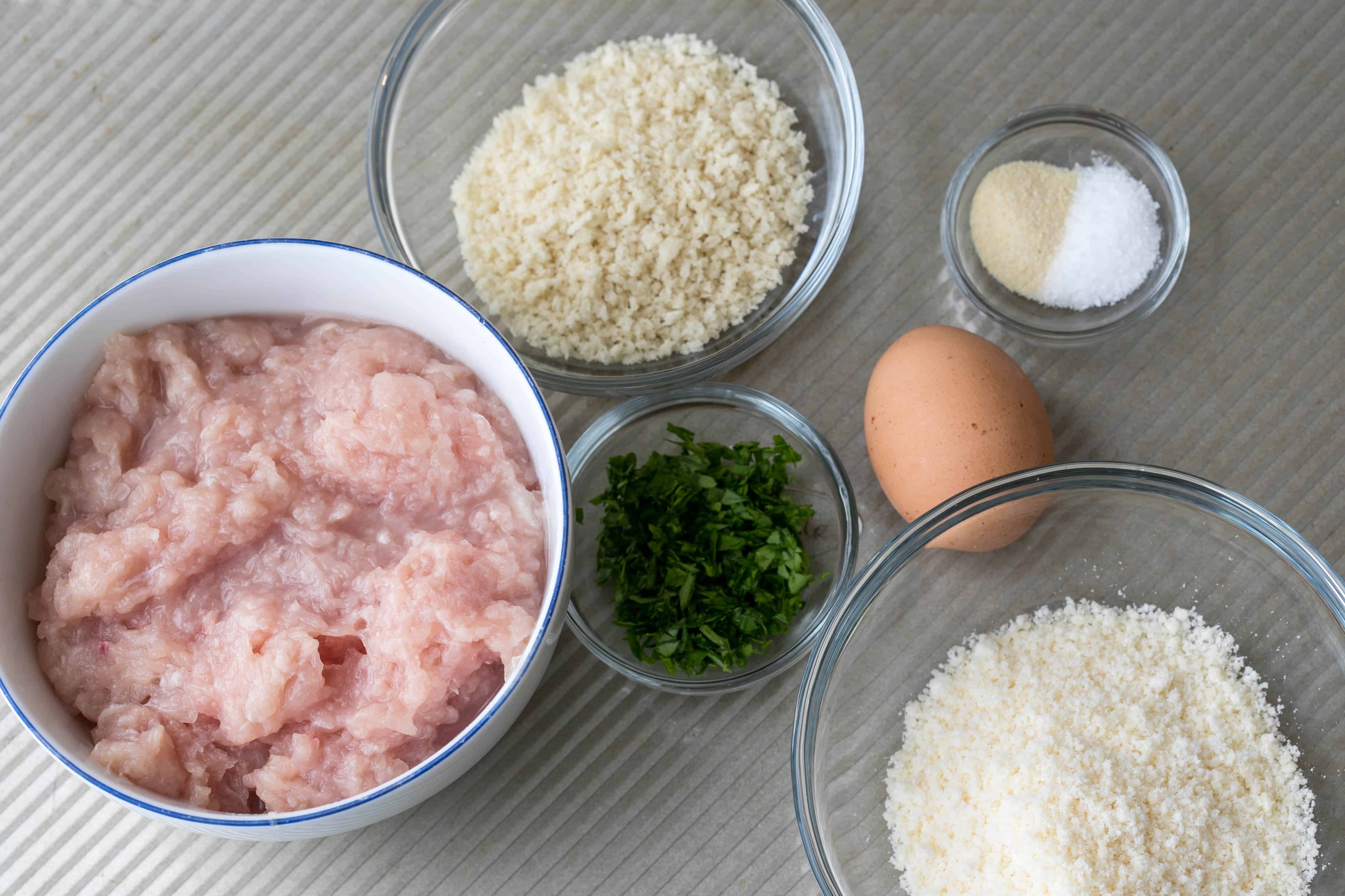 ingredients for chicken parm meatballs: ground chicken, breadcrumbs, egg, parmesan cheese, parsley, garlic powder, salt