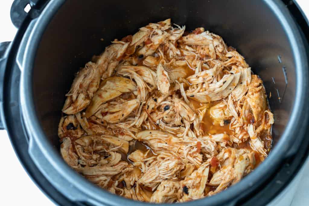 shredded chicken breasts with salsa in slow cooker
