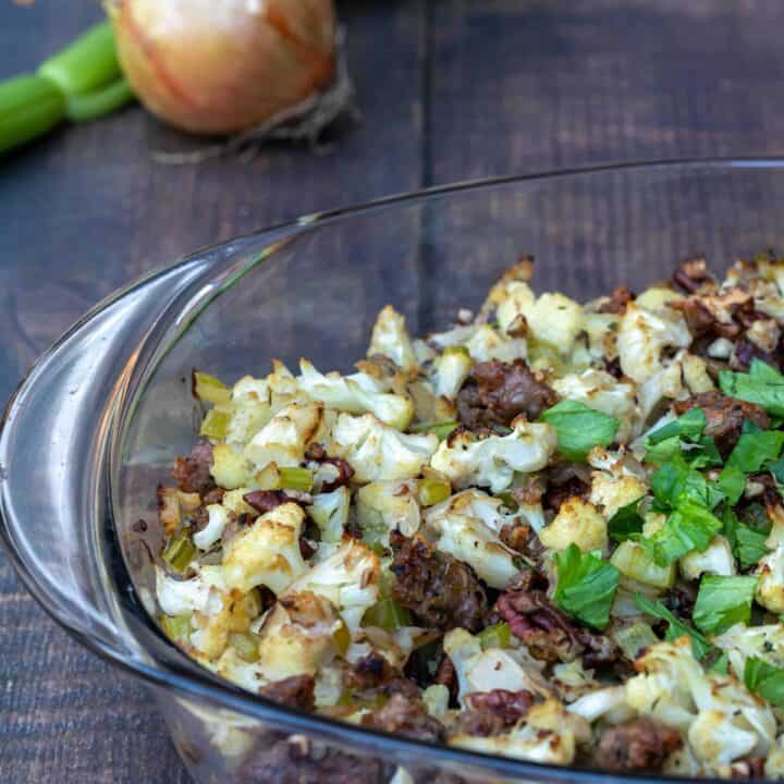 cauliflower stuffing with sausage and pecans in baking dish
