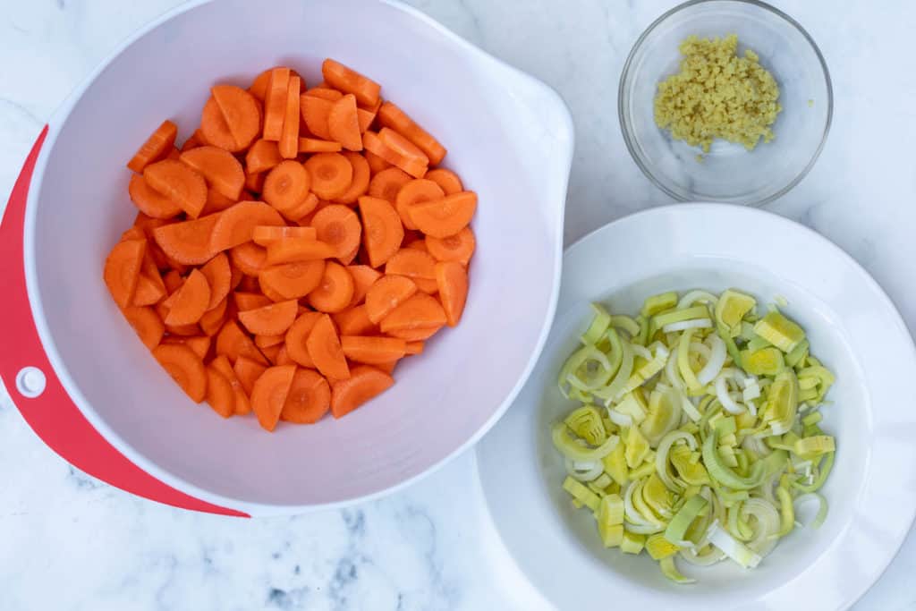 prepped ingredients for carrot ginger soup: carrots, leeks, ginger