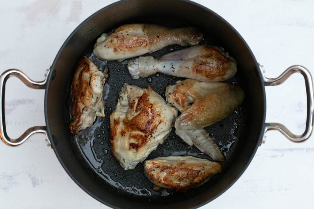 chicken pieces browned in saucepan