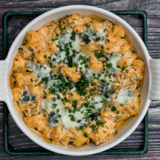 close-up of buffalo cauliflower dip in baking dish on cooling rack