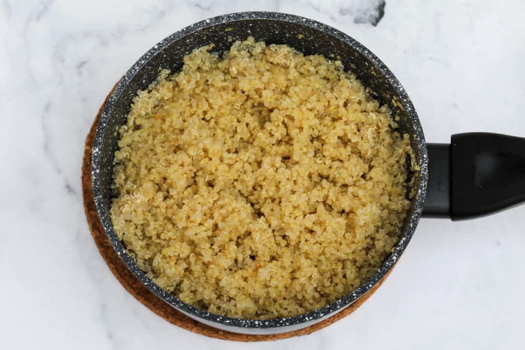 small saucepan with cooked quinoa
