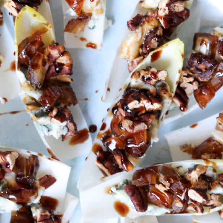 Close up of endive appetizer with blue cheese and pecans