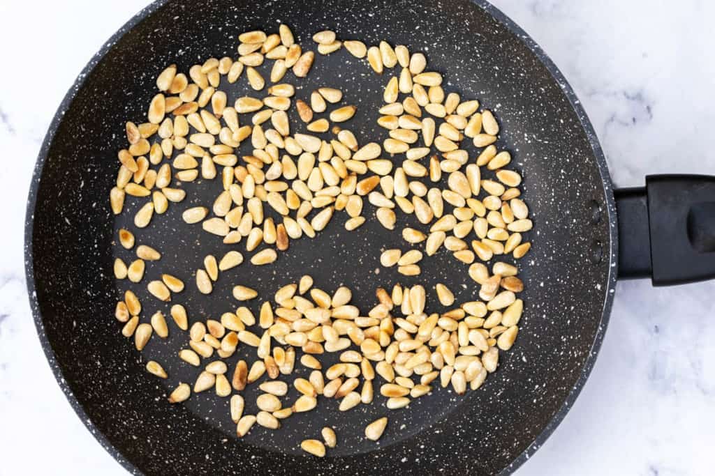 toasted pine nuts in skillet