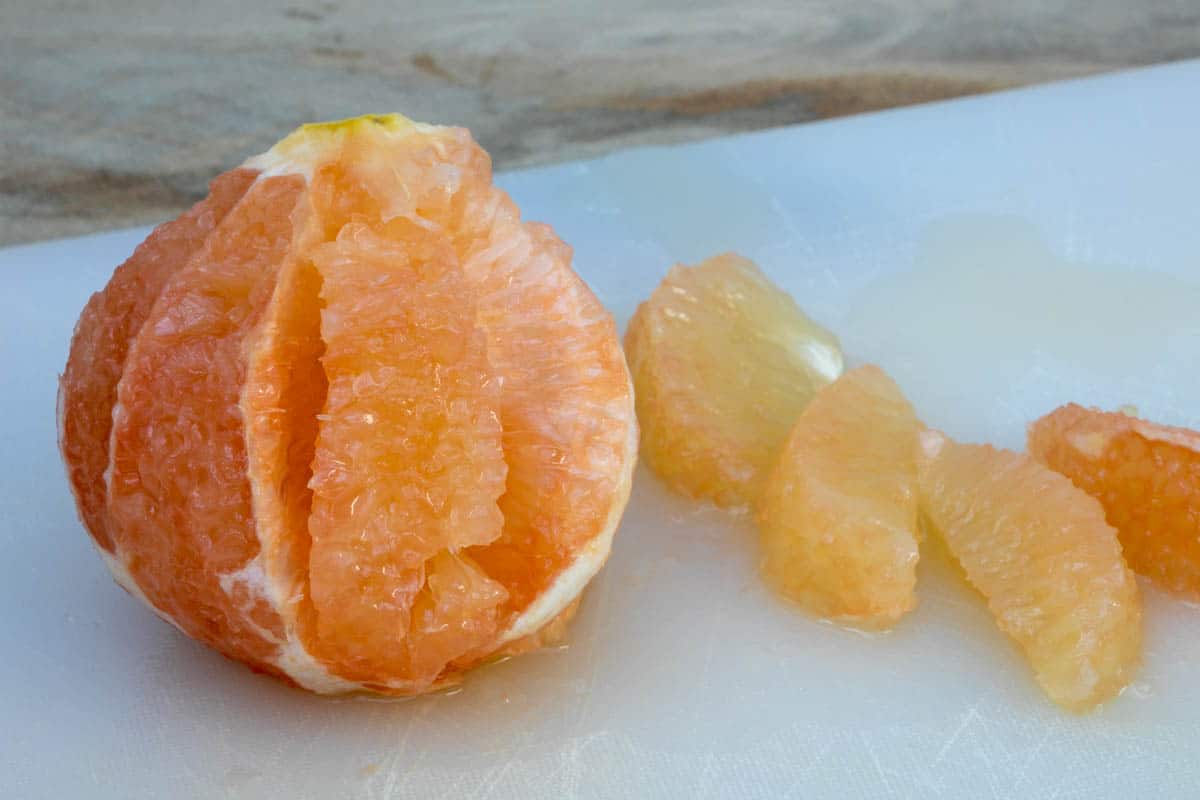 cutting grapefruit sections out of grapefruit