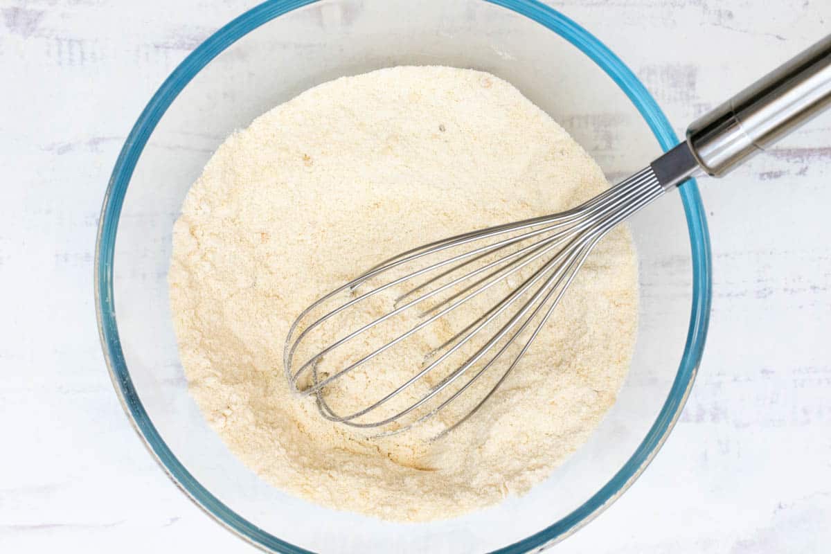 flour, almond flour, sugar, baking powder, and salt in bowl with whisk