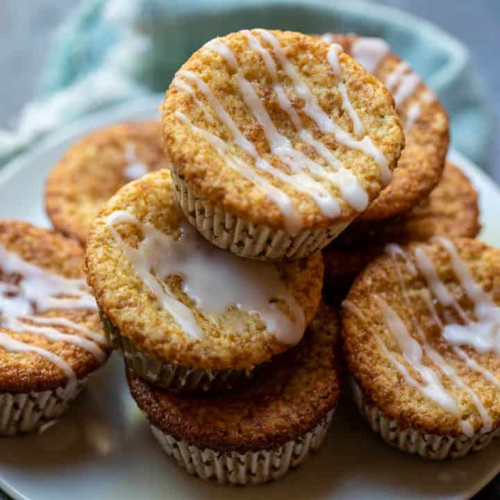 lemon almond flour muffins stacked on plate