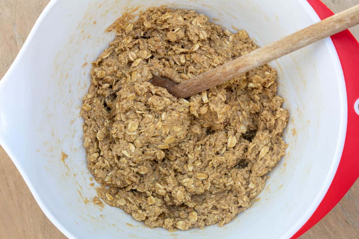batter for almond flour oatmeal cookies minus chocolate chips in mixing bowl with wooden spoon