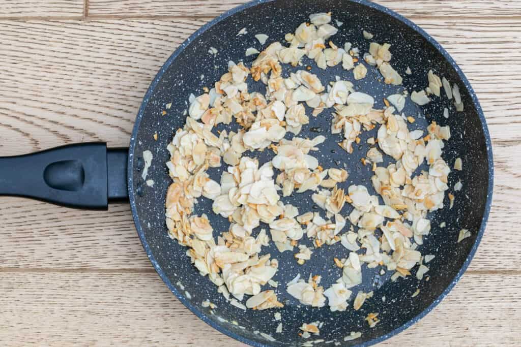 toasted almonds and garlic in skillet