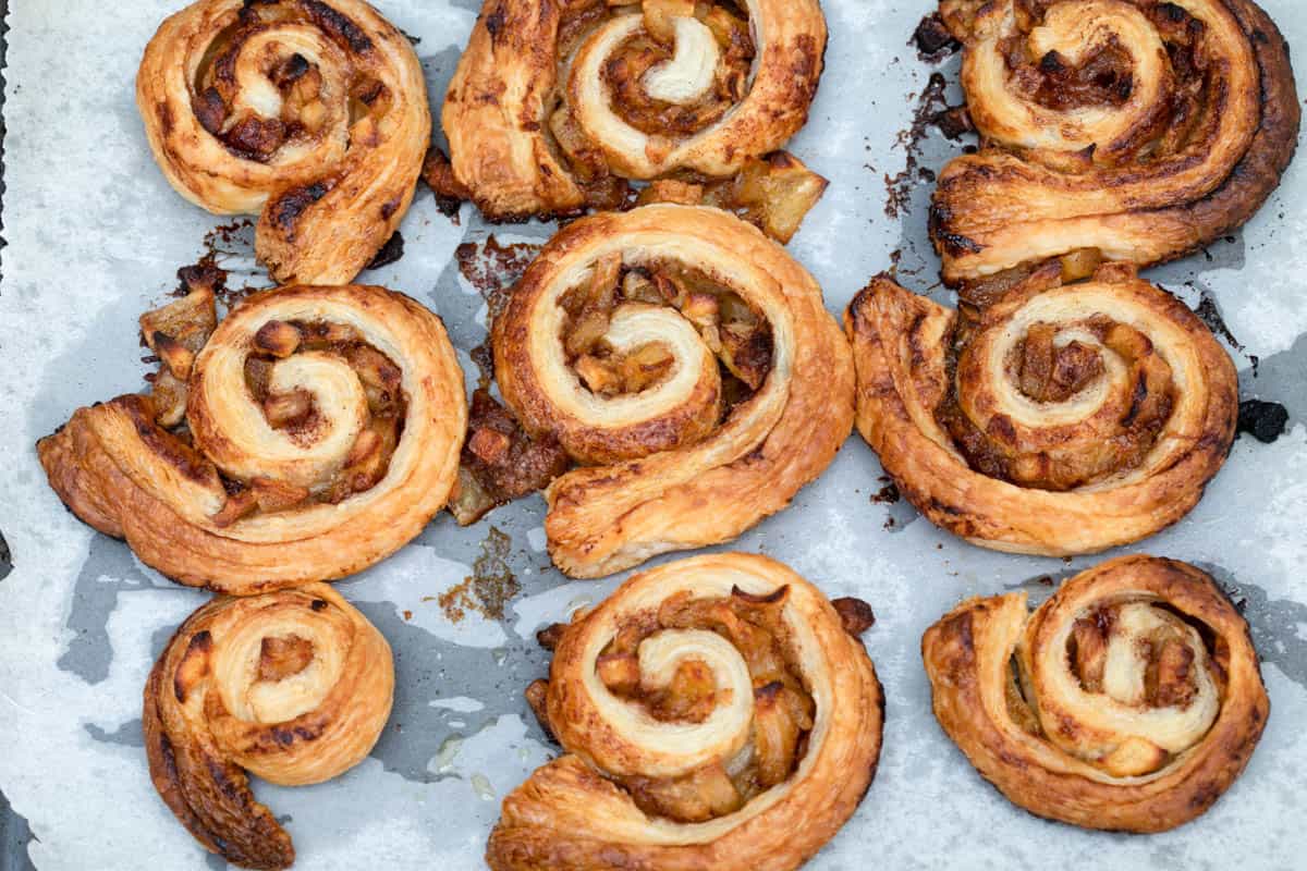 baked puff pastry cinnamon rolls with apple on sheet pan