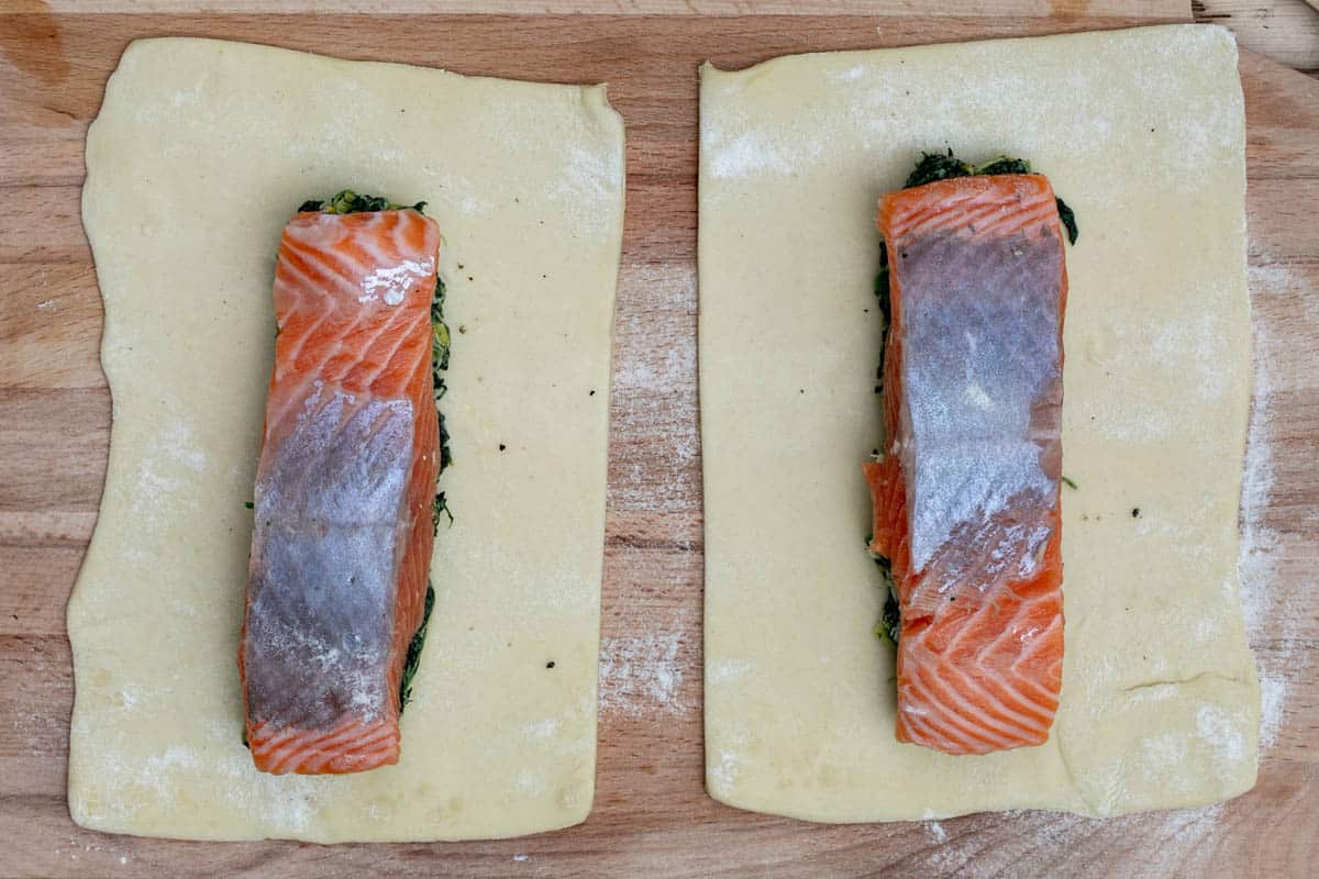 2 pieces of puff pastry with salmon and spinach mixture upside down on top of each