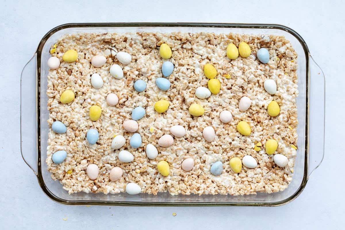 baking pan filled with easter Rice Krispie treats topped with mini eggs