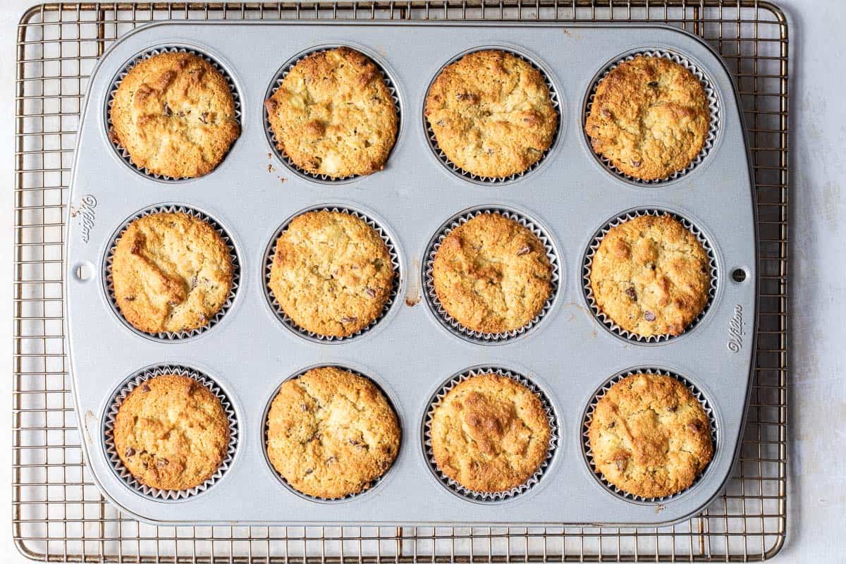 cupcake tin filled with baked almond flour banana muffins on cooling rack