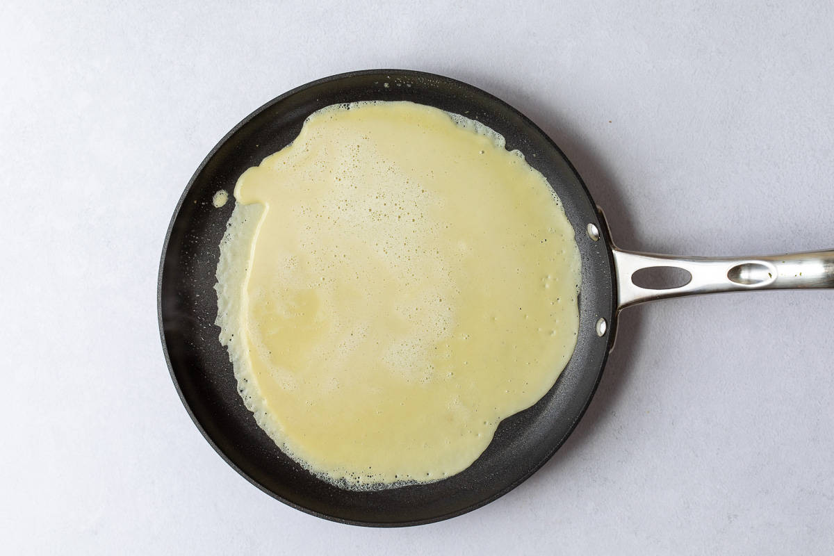 crepe in crepe pan before flipping