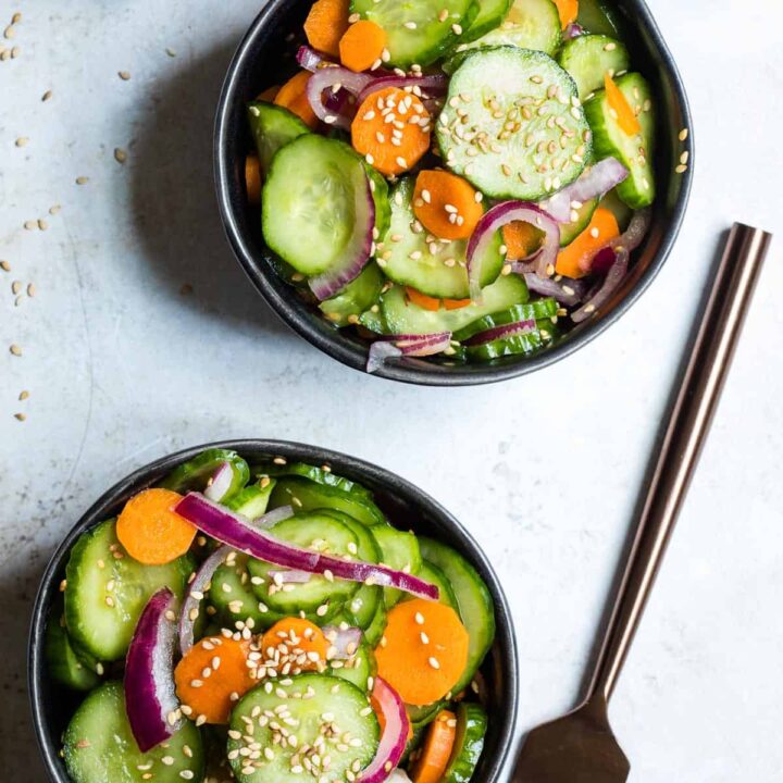 two small bowls of cucumber carrot salad next to fork