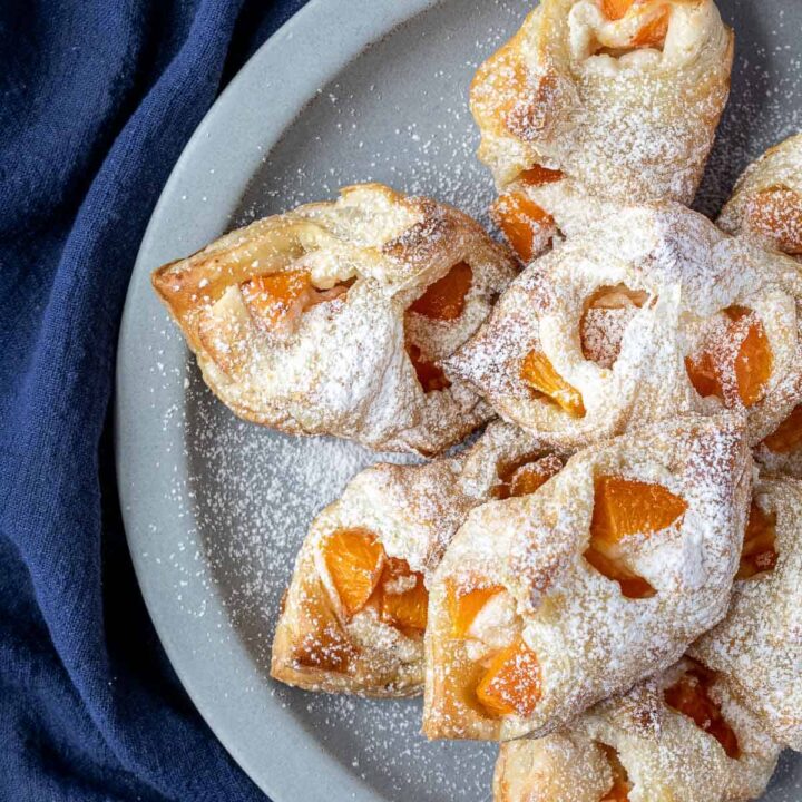 apricot danishes on plate next to napkin