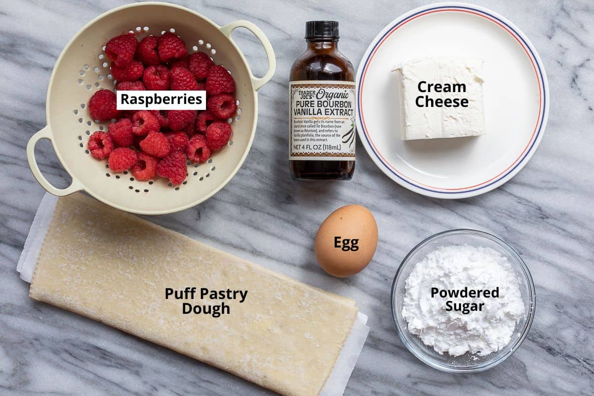 puff pastry dough, raspberries, vanilla extract, egg, cream cheese, and powdered sugar
