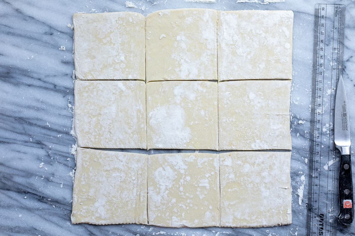 rolled puff pastry dough cut into nine squares