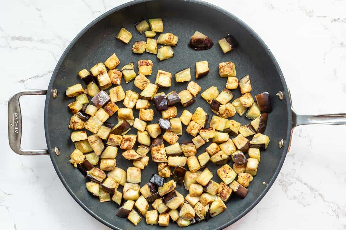 sauteed eggplant cubes in large skillet.