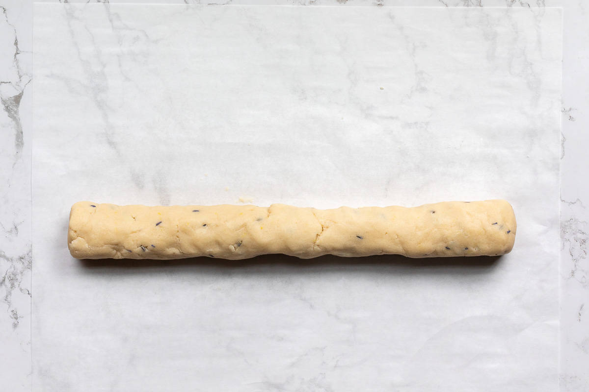 log of lemon lavender cookie dough on a piece of parchment paper.