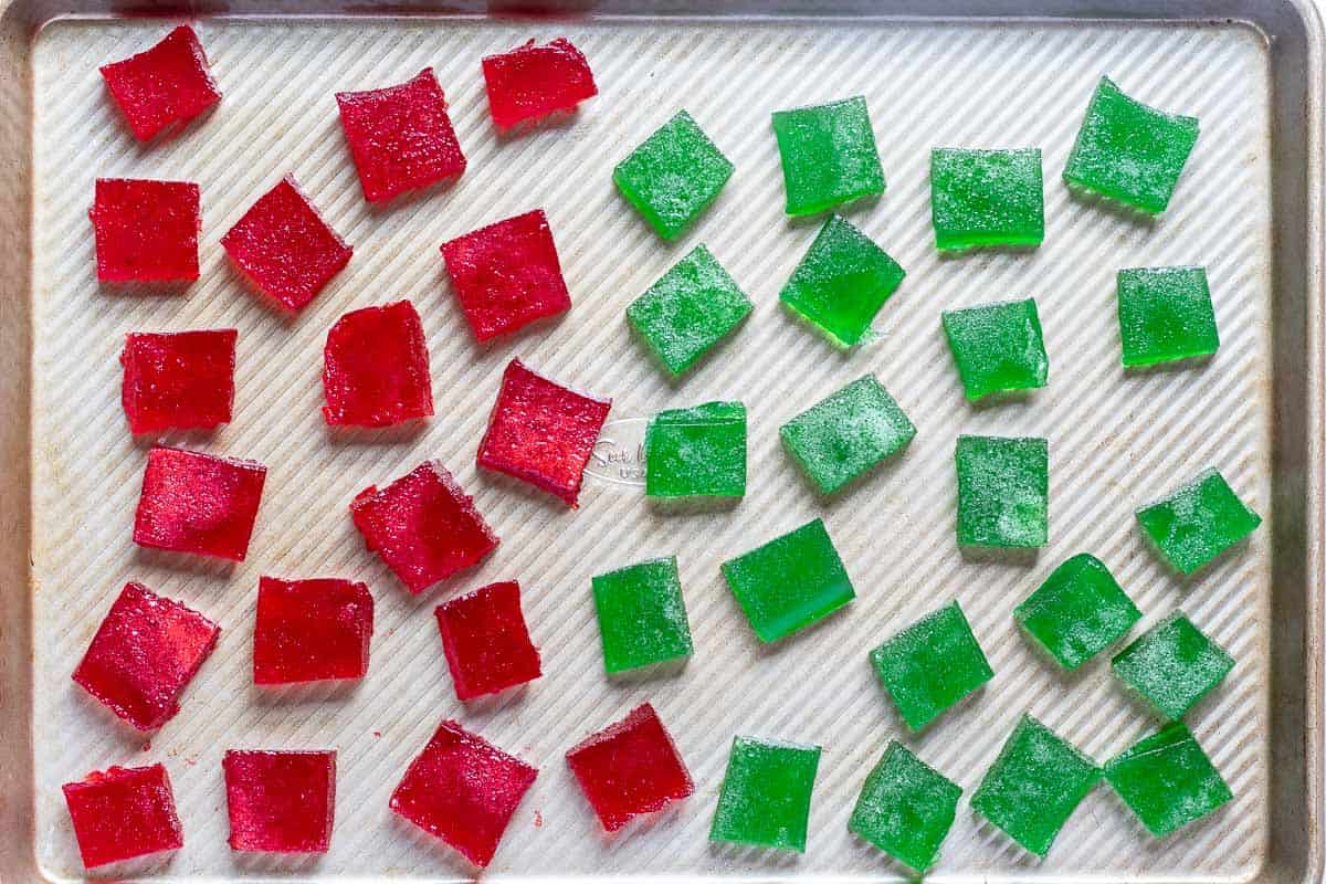 red and green Christmas gumdrops drying on baking sheet before being coated in sugar.