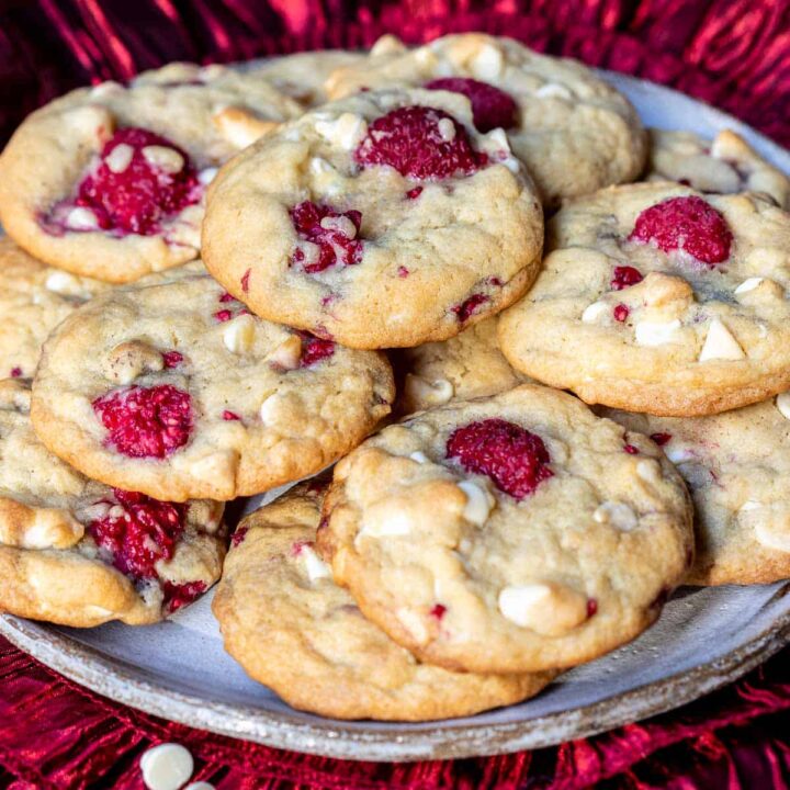 stacked white chocolate raspberry cookies on plate.