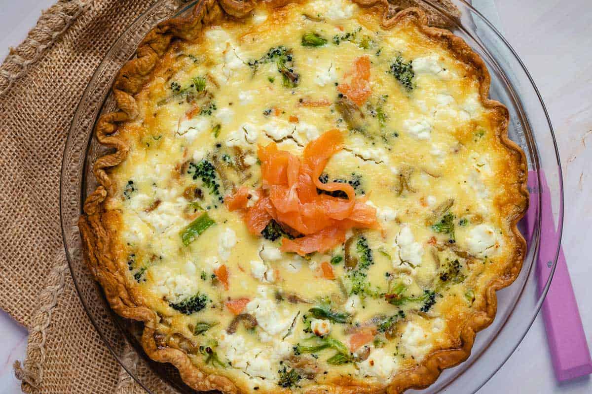 salmon quiche with knife. 