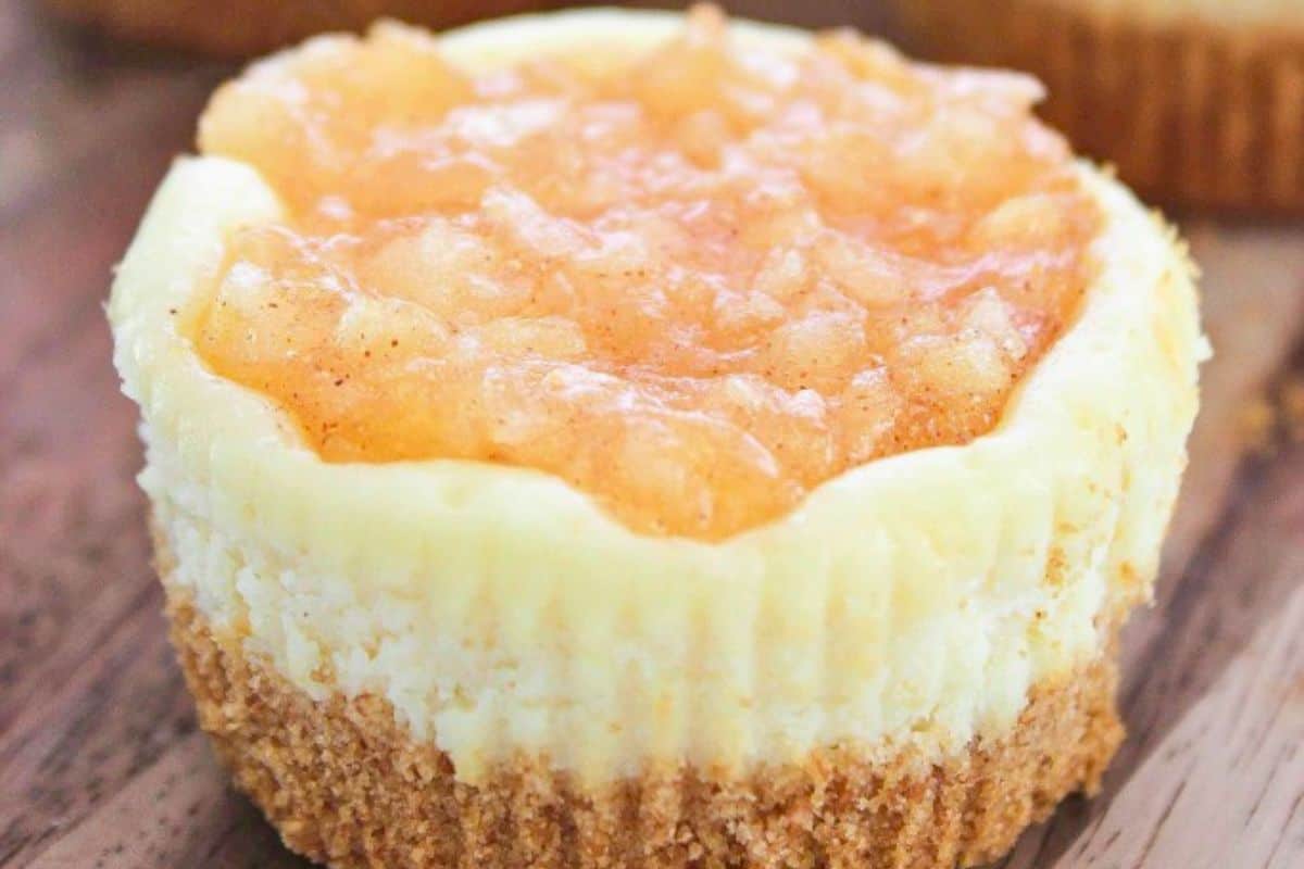 A must-make mini cheesecake with a graham cracker crust, topped with a chunky apple cinnamon mixture.