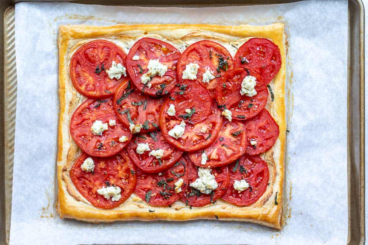 baked puff pastry tomato tart with Boursin and basil.