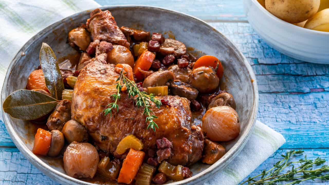 Coq au vin - French dish of chicken, baconm mushrooms and vegetables braised with red wine