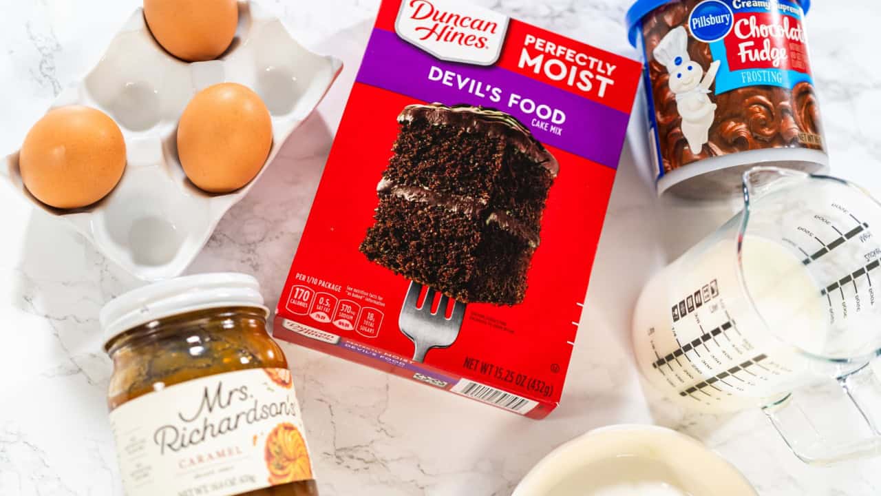 Gathered on the kitchen counter are the essential ingredients needed to create irresistible chocolate cupcakes, using a convenient cake mix and luscious