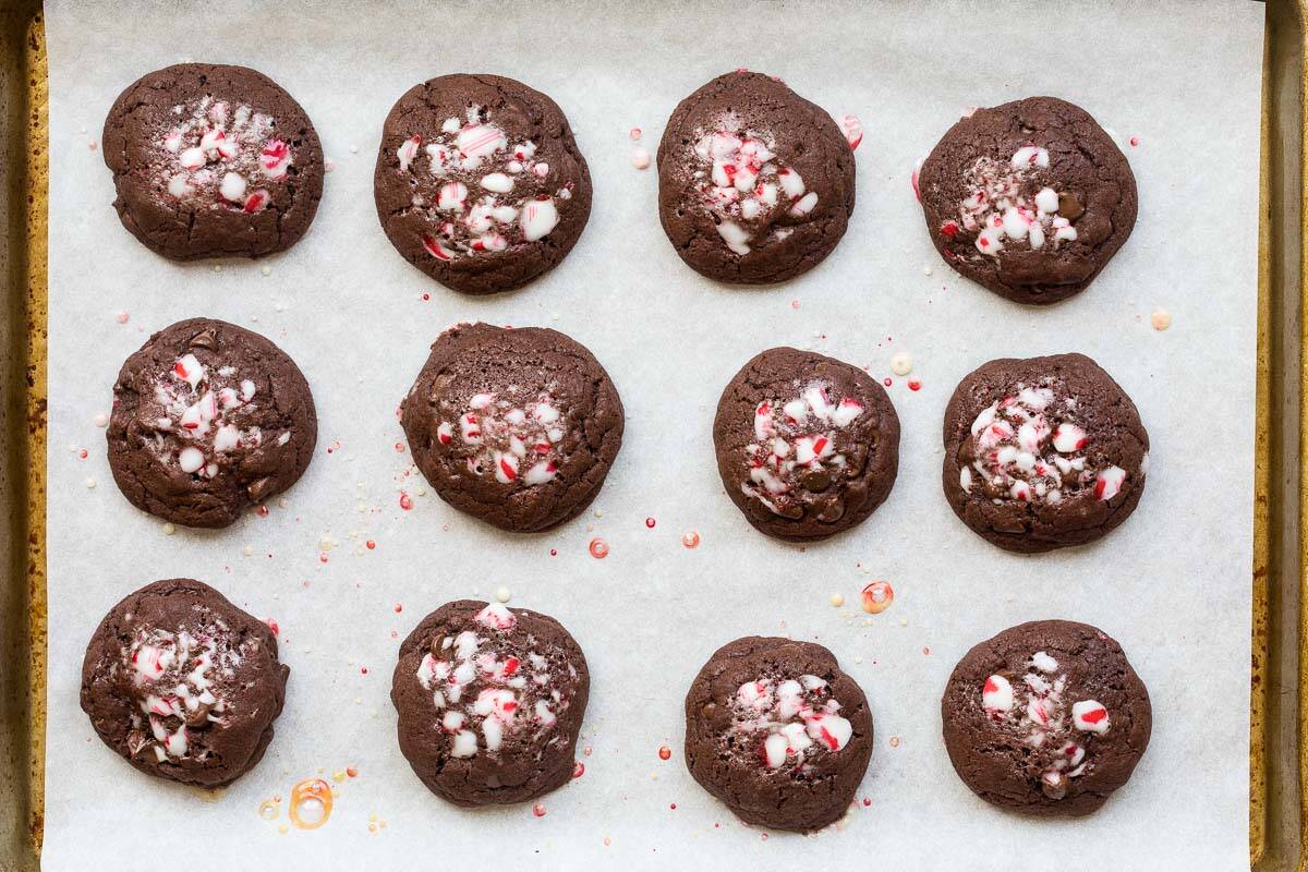 baked chocolate peppermint cookies on a parchment-lined sheet pan.