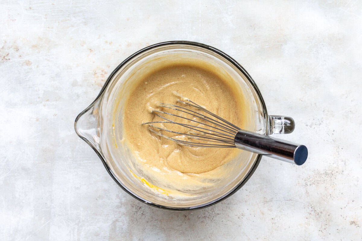 eggs, sugars, and melted butter whisked together in mixing bowl with wire whisk.