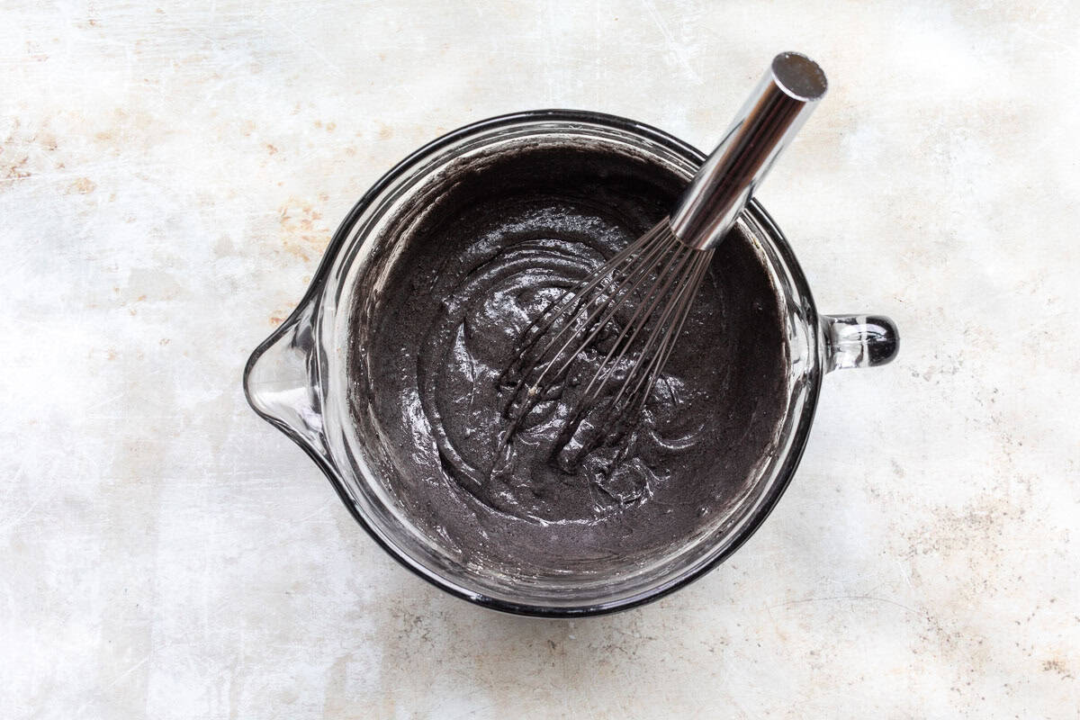 black cocoa powder added to liquid ingredients.