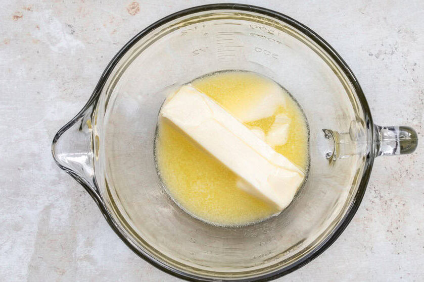 softened butter in glass mixing bowl.