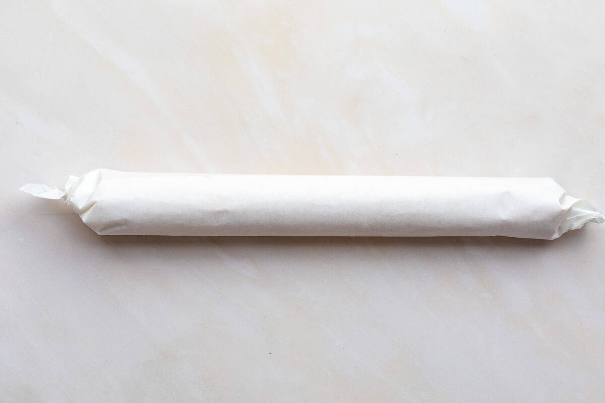 cheese sable dough wrapped in parchment paper.