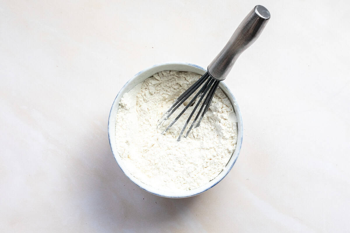 dry ingredients for mini egg cookies in a small bowl with a whisk.