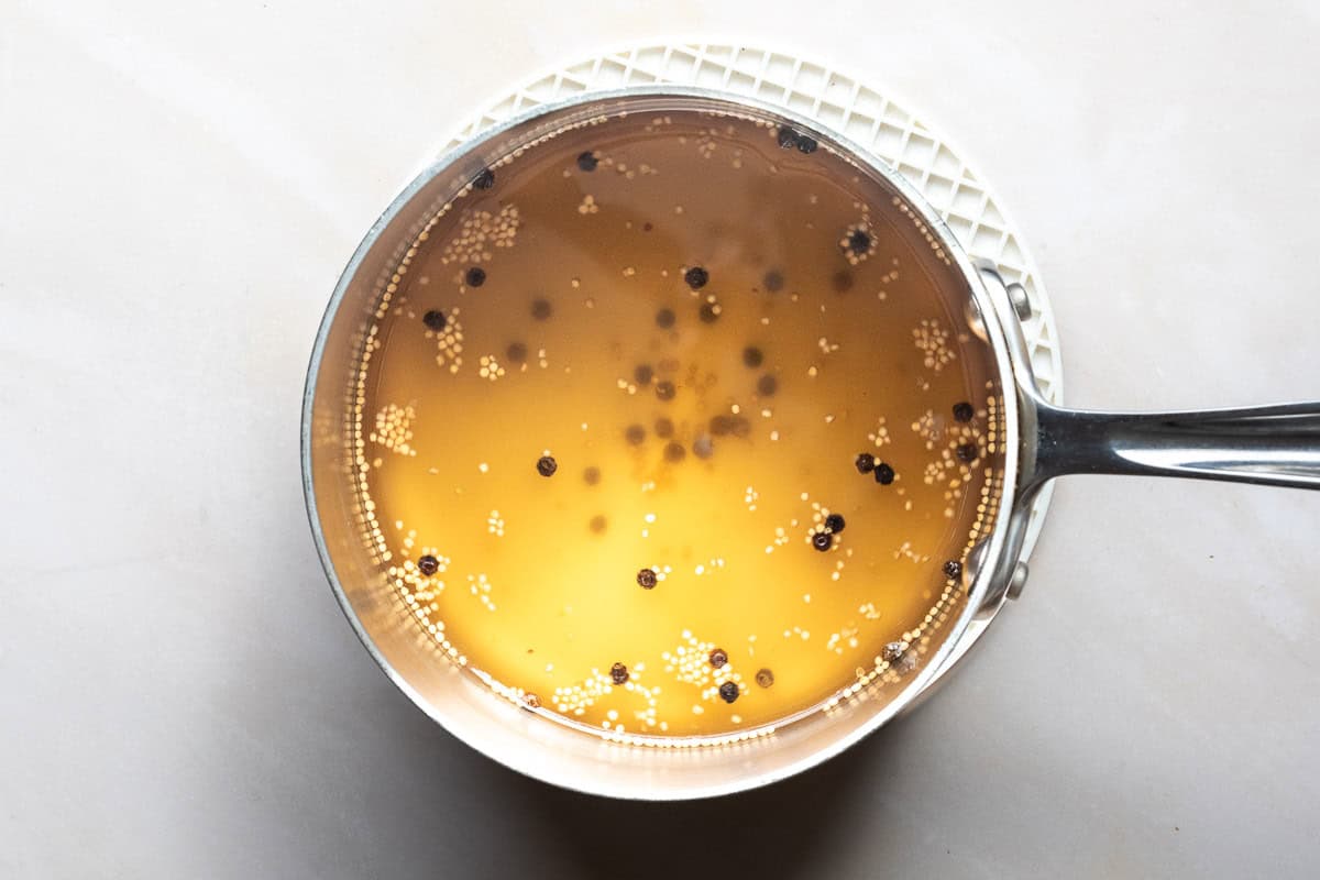 Pickling brine for radishes in a small stainless steel saucepan.