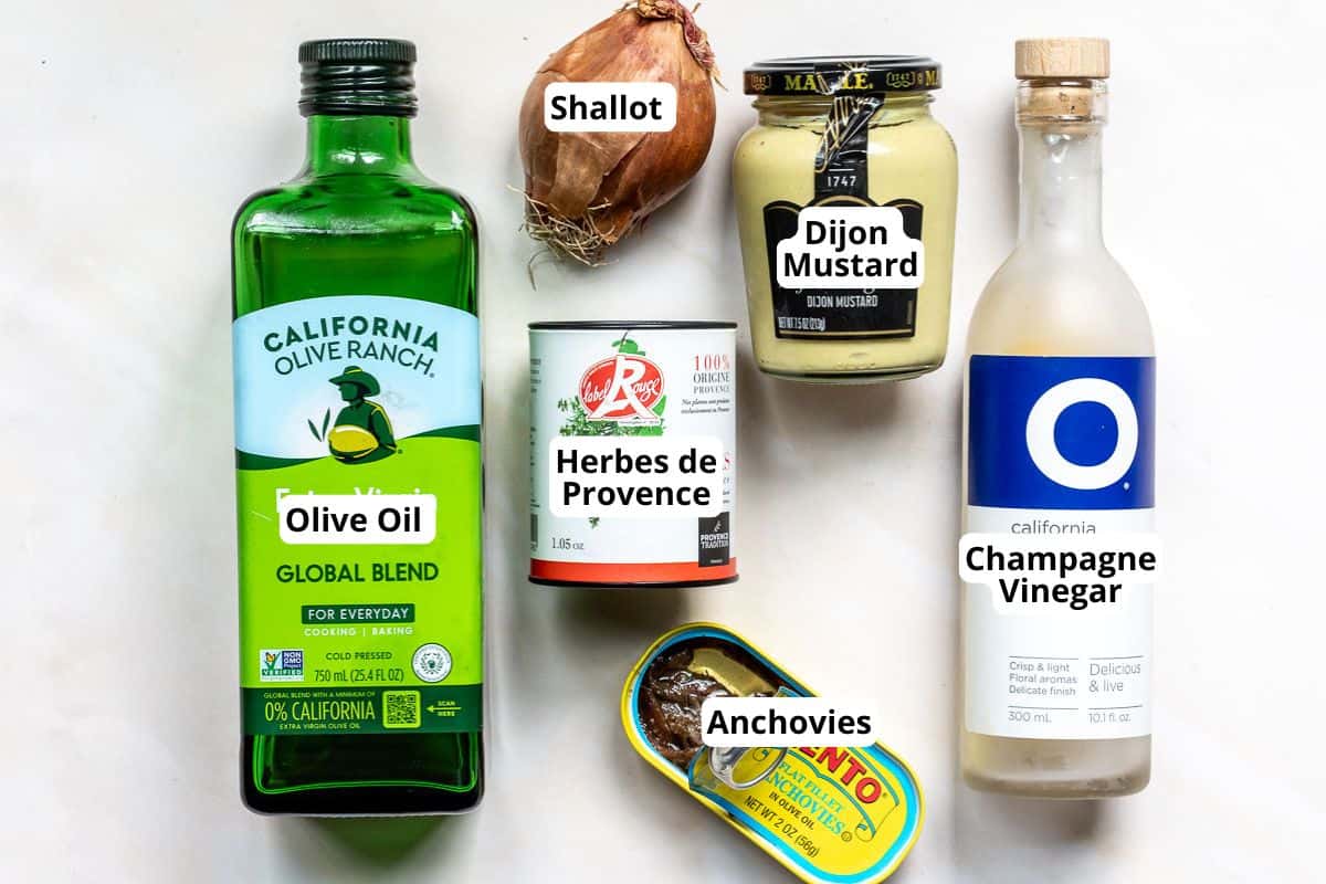 Ingredients for a vinaigrette: olive oil, shallot, Dijon mustard, Herbes de Provence, anchovies, and champagne vinegar.